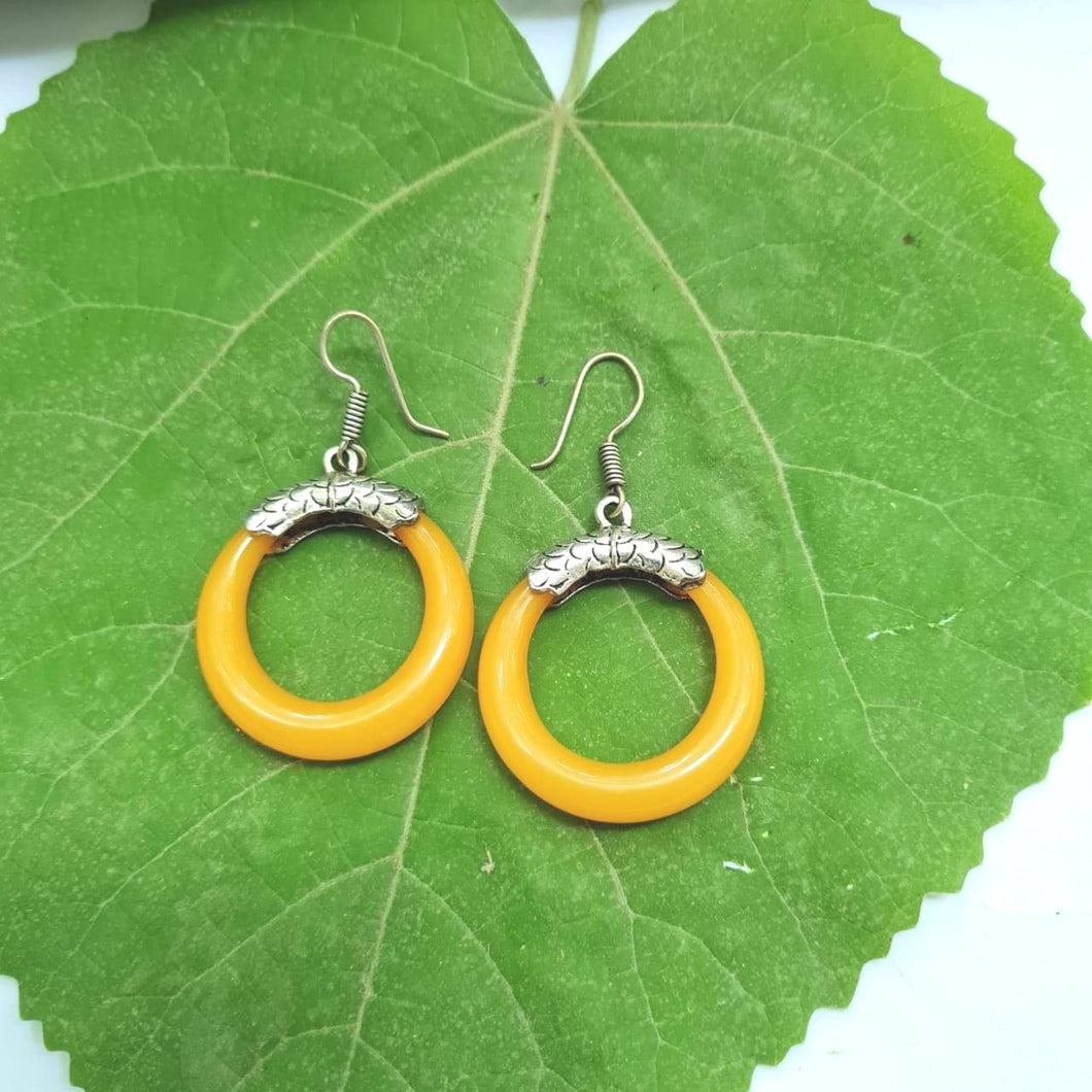 Gemzlane  yellow oxidized circular fashion earrings.
